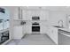 Bright white kitchen with stainless steel appliances and plenty of cabinet space at 4151 Sunrise S Dr, St Petersburg, FL 33705