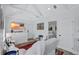 Bright living room features white furnishings, light wood floors, and view to bedroom at 4151 Sunrise S Dr, St Petersburg, FL 33705