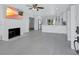 Bright open living room featuring a fireplace, ceiling fan, and views into the kitchen at 4151 Sunrise S Dr, St Petersburg, FL 33705