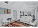Bright living room features white sofa, modern chairs and a colorful rug on light wood floors at 4151 Sunrise S Dr, St Petersburg, FL 33705
