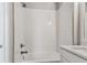 A pristine bathroom showcases a tub and shower with crisp white subway tile and sleek, modern fixtures at 445 31St N Way, St Petersburg, FL 33713