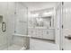 Bright bathroom features a glass shower, double vanity, and tile flooring at 445 31St N Way, St Petersburg, FL 33713