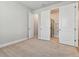 Bright, carpeted bedroom featuring modern doorways to the en-suite bathroom, and closet, with neutral paint at 445 31St N Way, St Petersburg, FL 33713