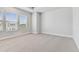 A spacious bedroom with lots of natural light from the multiple windows, carpet flooring, and neutral paint at 445 31St N Way, St Petersburg, FL 33713