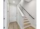 Bright entryway features a staircase with wooden steps, a handrail, and access to the upper floors at 445 31St N Way, St Petersburg, FL 33713