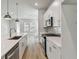 Bright kitchen featuring stainless appliances, white countertops, and modern fixtures, adjacent to a living area at 445 31St N Way, St Petersburg, FL 33713