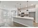 Open-concept kitchen and living area featuring a large island, stainless steel appliances, and modern lighting at 445 31St N Way, St Petersburg, FL 33713