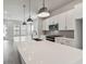 Modern kitchen featuring white cabinets, a large island with sink, and stainless steel appliances at 445 31St N Way, St Petersburg, FL 33713