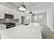 This kitchen has stainless steel appliances, white cabinets, gray backsplash and large island with sink at 445 31St N Way, St Petersburg, FL 33713