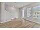 Neutral colored living room with staircase, windows, and light wood flooring at 445 31St N Way, St Petersburg, FL 33713