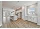 Open floor plan featuring a living room, kitchen, and dining area with light wood flooring at 445 31St N Way, St Petersburg, FL 33713