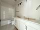 Modern bathroom featuring a double vanity, sleek fixtures, and a subway-tiled shower and tub combo at 5001 21St N Ave, St Petersburg, FL 33710