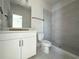 Stylish bathroom featuring a walk-in shower with gray tiling and a modern vanity with black hardware at 5001 21St N Ave, St Petersburg, FL 33710