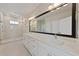 Spacious bathroom with double vanity, large mirror, and glass-enclosed shower at 5001 21St N Ave, St Petersburg, FL 33710