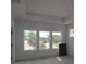 Bright, airy main bedroom with tray ceiling, large windows providing natural light, and a serene atmosphere at 5001 21St N Ave, St Petersburg, FL 33710