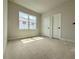 Bright bedroom with neutral walls and ample natural light from the window and two doors at 5001 21St N Ave, St Petersburg, FL 33710
