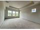 Unfinished primary bedroom with tray ceiling and ample natural light from large windows at 5001 21St N Ave, St Petersburg, FL 33710