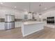 A spacious kitchen with stainless steel appliances, a center island, and white cabinetry at 5001 21St N Ave, St Petersburg, FL 33710