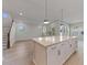 An open kitchen with stainless steel appliances, light wood floors, a center island, and a view to the living space at 5001 21St N Ave, St Petersburg, FL 33710