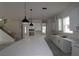 Spacious kitchen featuring a large island with modern pendant lighting and white cabinetry, offering ample storage at 5001 21St N Ave, St Petersburg, FL 33710