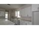 Well-appointed kitchen boasts sleek white cabinets, modern black hardware, and ample counter space for meal preparation at 5001 21St N Ave, St Petersburg, FL 33710