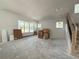 Spacious living room with a staircase and plenty of natural light from large windows at 5001 21St N Ave, St Petersburg, FL 33710