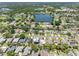 Aerial view of a well-maintained neighborhood featuring a central lake and various home styles. Lush landscaping surrounds property at 5731 Denver Ne St, St Petersburg, FL 33703