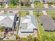 An aerial view of the house highlights the metal roof and landscaped backyard with a paver patio at 5731 Denver Ne St, St Petersburg, FL 33703