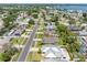 Aerial view of a suburban street featuring well-maintained homes, mature trees, and lush landscaping; home with metal roof at 5731 Denver Ne St, St Petersburg, FL 33703