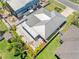 A lush, landscaped backyard and metal roof highlight this home in an aerial view of the property at 5731 Denver Ne St, St Petersburg, FL 33703