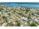 Expansive aerial view of a charming neighborhood with waterfront access and lush greenery with a metal roof home in the foreground at 5731 Denver Ne St, St Petersburg, FL 33703