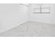 Clean and bright bedroom with marble floors, a window with blinds, and a closet at 5731 Denver Ne St, St Petersburg, FL 33703