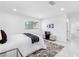 Bright bedroom featuring white walls, decorative rug, and upholstered bench at 5731 Denver Ne St, St Petersburg, FL 33703
