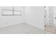 Bright bedroom featuring marble floors, a window with blinds, and fresh white paint at 5731 Denver Ne St, St Petersburg, FL 33703