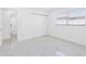 Bright bedroom with marble floors, window with blinds, and access to another room at 5731 Denver Ne St, St Petersburg, FL 33703