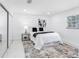 Bedroom featuring a queen bed, sliding closet, and large window at 5731 Denver Ne St, St Petersburg, FL 33703