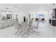 Elegant dining area with a modern glass table and views into the living space at 5731 Denver Ne St, St Petersburg, FL 33703