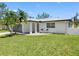 Charming single story home with a manicured lawn, grey metal roof, and front patio at 5731 Denver Ne St, St Petersburg, FL 33703