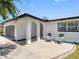 Covered front porch with seating area, offering a cozy entrance to the home at 5731 Denver Ne St, St Petersburg, FL 33703