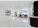 Spacious living room with marble floors, seating, and a stylish bar area at 5731 Denver Ne St, St Petersburg, FL 33703
