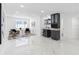 Open-concept living room with marble flooring and a modern bar area at 5731 Denver Ne St, St Petersburg, FL 33703