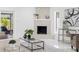 Bright living room with a fireplace, glass shelving, and stylish decor at 5731 Denver Ne St, St Petersburg, FL 33703