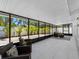 Bright sunroom featuring tile floors and floor to ceiling windows with outside views of tropical landscaping at 5731 Denver Ne St, St Petersburg, FL 33703