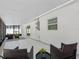 Bright patio features tile floors, comfortable wicker seating, and glass sliding door entry to interior of home at 5731 Denver Ne St, St Petersburg, FL 33703