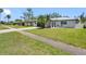 Street view showcasing a well-maintained lawn, driveway, and the home's exterior at 5731 Denver Ne St, St Petersburg, FL 33703
