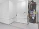 Utility area featuring a water heater and painted concrete floors at 5731 Denver Ne St, St Petersburg, FL 33703
