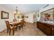 Cozy dining area with wooden furniture and a view of the adjacent kitchen and decor at 6077 Bahia Del Mar Blvd # 123, St Petersburg, FL 33715