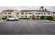 Exterior view of condo buildings showcasing well-maintained landscaping and ample parking at 6077 Bahia Del Mar Blvd # 123, St Petersburg, FL 33715
