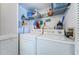 Laundry room with washer, dryer, wire shelving, and storage space at 6077 Bahia Del Mar Blvd # 123, St Petersburg, FL 33715