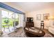 Living room with sliding doors that open onto a serene outdoor seating area on a golf course at 6077 Bahia Del Mar Blvd # 123, St Petersburg, FL 33715